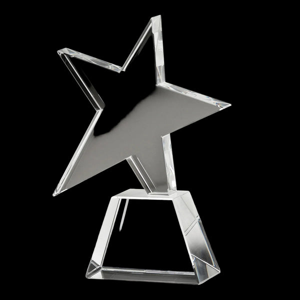 Clear glass star-shaped trophy on a dark background